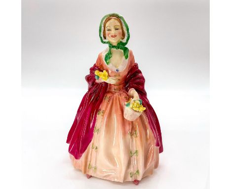 Glazed finish figure depicting woman dressed in dark and light pink with bow accents holding a basket of flowers and green bo