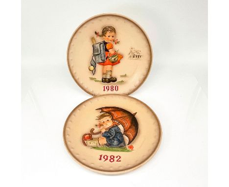 10th and 12th annual decorative plates celebrating 100 years of Goebel. Hand-painted porcelain 1982 Umbrella Girl and 1980 Fi