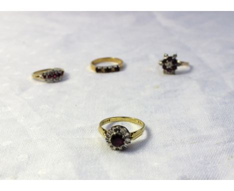 A ruby and diamond dress ring, with a central ruby and ten diamonds to a white metal setting and 18ct yellow gold shank, toge