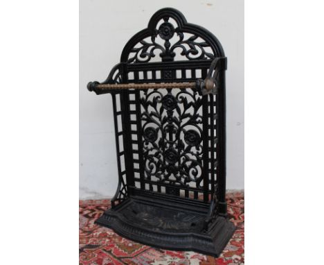 A cast iron stick stand, with pierced floral and leaf decoration, the drip tray with scrolling shells, 81.5cm high