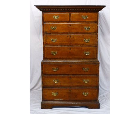 A 19th century oak and mahogany crossbanded chest on chest, the moulded dentil cornice above two short drawers and three long
