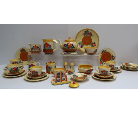 A Clarice Cliff matched crocus pattern part tea and dessert set comprising a teapot and stand, three jugs, three bowls, one e