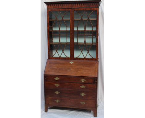 A George III mahogany bureau bookcase, the moulded cornice above a pair of glazed doors with glazing bars, with a sloping fal