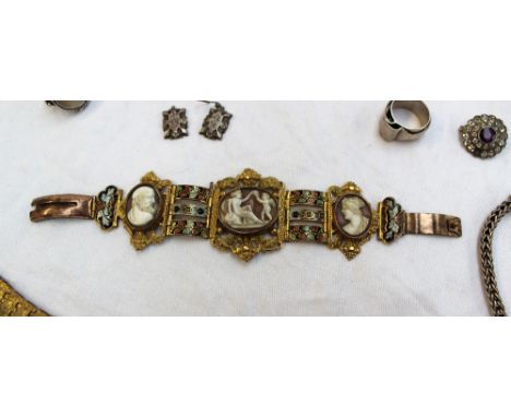 A cameo bracelet, set with three cameos to a yellow metal and enamel decorated strap, together with assorted dress rings, nec