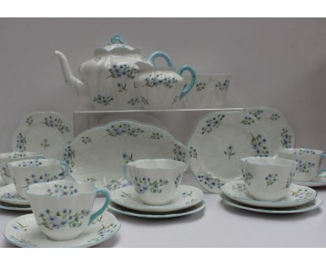 A Shelley part tea set decorated in the Blue Rock pattern No.13591, including a teapot, oval dish, cream jug, slops basin, si