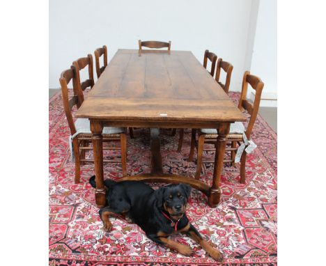 An 18th century style oak refectory table, the rectangular planked top on turned legs united by a flat stretcher, 97cm wide x