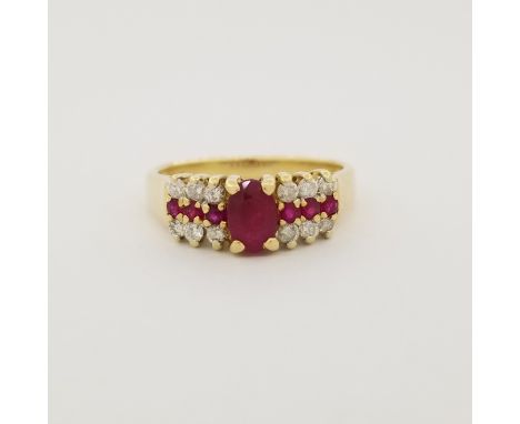 14K Gold Ruby &amp; Diamond Ring. This ring contains an oval cut ruby flanked by rows of small round cut diamonds and rubies.