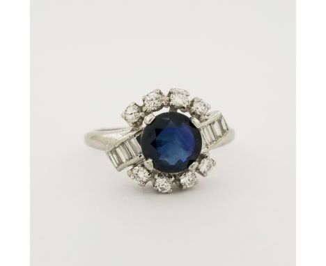 Platinum Sapphire &amp; Diamond Ring. This Platinum ring is mounted with a round cut sapphire surrounded by (8) round cut dia