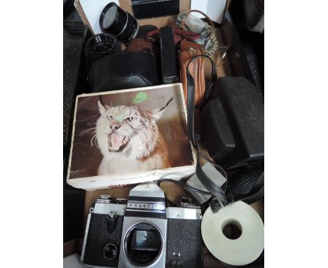 A tray of camera equipment including Praktica camera, Kodak 255X instamatic, various lenses and light meters etc