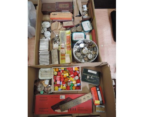 Two trays of watch repair equipment, including watch faces, springs, hands, movements, roller pins and waterproof case opener