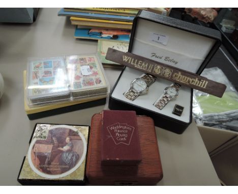 A pair of Fred Belay watches in case and a selection of vintage playing cards