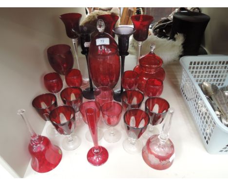 A collection of cranberry/ruby glass