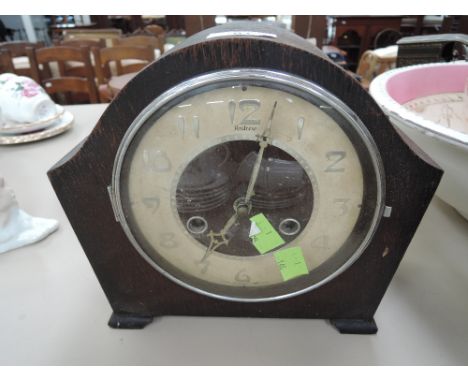 A 1920s oak cased mantel clock