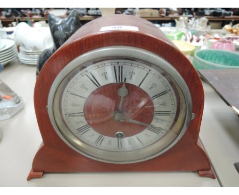 A mid 20th Century stained case mantel clock