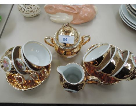 A gilt part coffee service with transfer print design