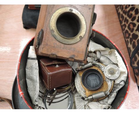 A selection of photographic equipment including a Bausch & Lamb Unicum diaphragm and shutter mechanism, a roller blind shutte