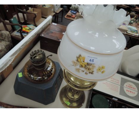 A brass oil lamp with shade and chimney and a oil lamp on wooden base