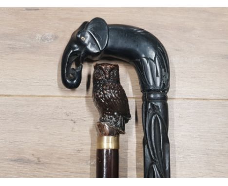 CARVED AFRICAN HARDWOOD WALKING STICK WITH CARVED HORN ELEPHANT HANDLE TOGETHER WITH ANOTHER WALKING STICK WHICH HAS A COMPOS