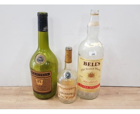 3 LARGE VINTAGE ALCOHOL BOTTLES UNFORTUNATELY EMPTY INCLUDES HENNESSY COGNAC J AND F MARTELL COGNAC AND BELLS OLD SCOTCH WHIS