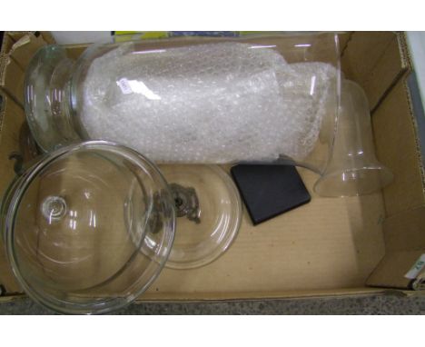 Large glass storage jar and similar hanging item.