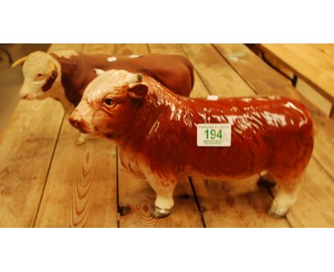 Beswick Matt Hereford Bull A2542 together with similar unbranded item. (2).