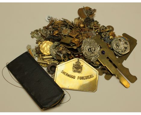 Cap badges - tin packed full of old cap badges, pin badges, button cleaners, bed plate, etc and a United Metal Machine Gun Of