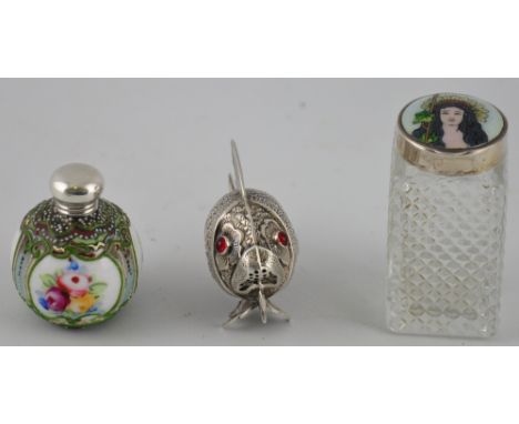 A silver mounted glazed and enamelled ceramic snuff bottle, together with a white metal pepperette modelled as a fish, and an