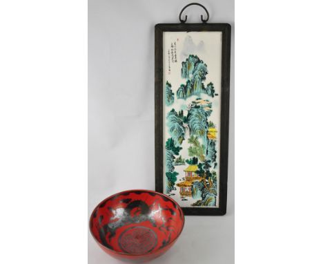 A Chinese painted ceramic panel of a pastoral scene 49x16cm, together with a red glaze bowl decorated with a black dragon, be