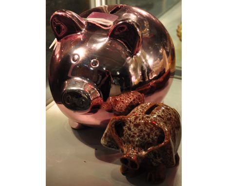 A Welsh pottery earthenware pig money bank together with a pink lustre ceramic piggy bank 