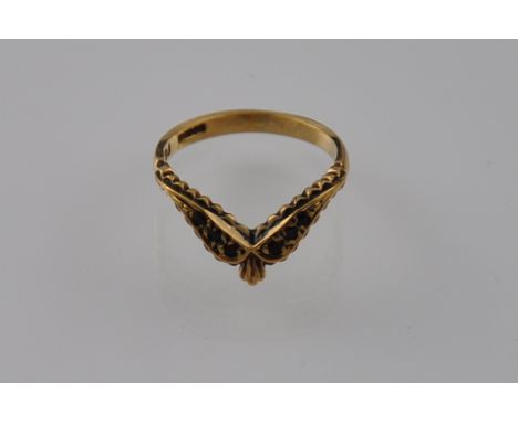 An antique 14 carat ruby wishbone ring