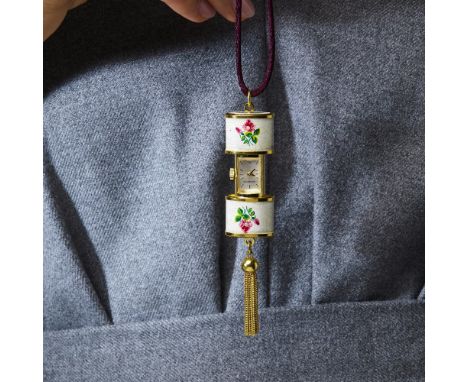 BUCHERER - ANNEES 1960MONTRE PENDENTIFElle est de forme ovalisée en métal doré émaillé de fleurs. Remontoir avec les deux vol