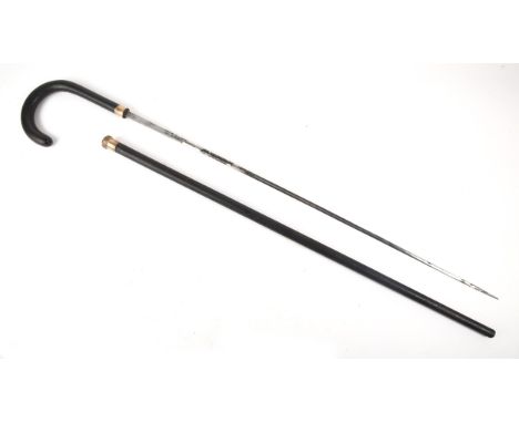 An early 20th century gilt metal mounted, ebony sword stick, the single fullered 27" (69cm) blade etched 'Toledo', on crook h