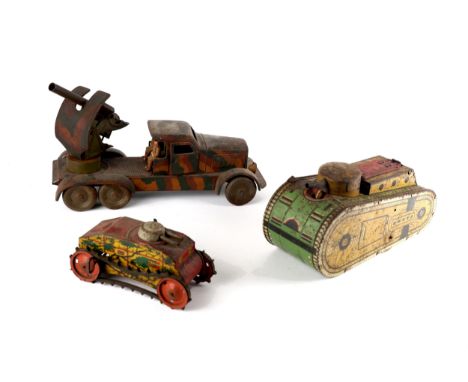 Tinplate military toys, a six-wheel lorry-mounted gun with opening doors and figures, 13" (33cm) long; a Marx large clockwork