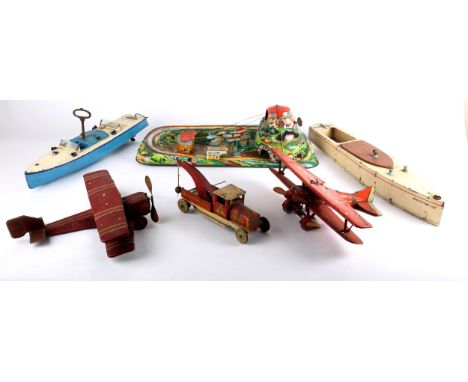 Tinplate toys. A collection of early 20th century tinplate toys including, an English clockwork biplane, maroon; a German clo