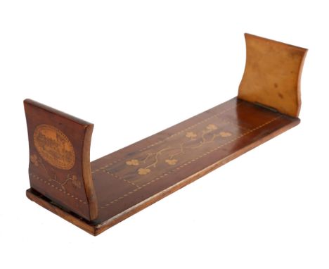 A late 19th Century Irish yew-wood Killarney wood book trough, the base inlaid with trailing shamrocks, the hinged ends with 