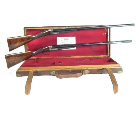 Fine cased pair of Westley Richards side by side 12 bore shotguns, serial numbers 14878 and 14879, numbered in gilt 1 and 2, 