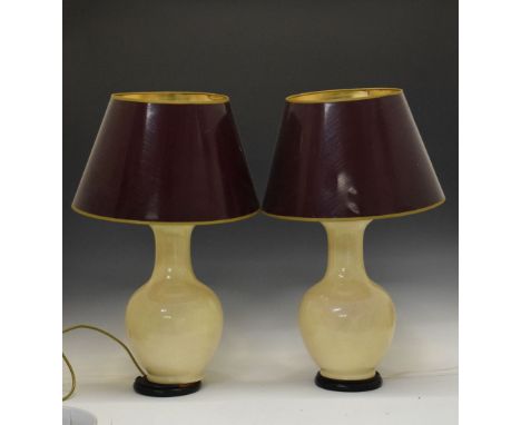 Pair of ceramic cream table lamps having cardboard shades, on turned wooden stands, overall height 65cm  