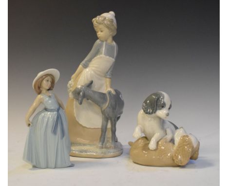 Three Spanish porcelain figurines, Nao girl with goat, 30cm high, Nao puppies and Lladro girl (3)  