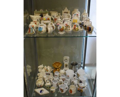 Group of assorted crested china wares to include fireplace, Coronation chair, camel, tank, longcase clock etc  