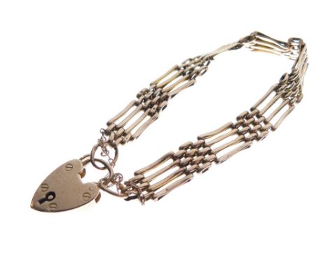 Yellow metal gate-link bracelet stamped 9ct, together with a 9ct gold heart-shaped padlock, 14.2g approx  