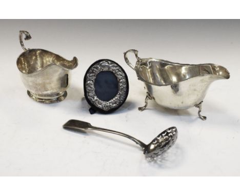 George V silver sauceboat, London 1930, another, 1926, George III straining ladle, 7.1toz approx, together with a small oval 