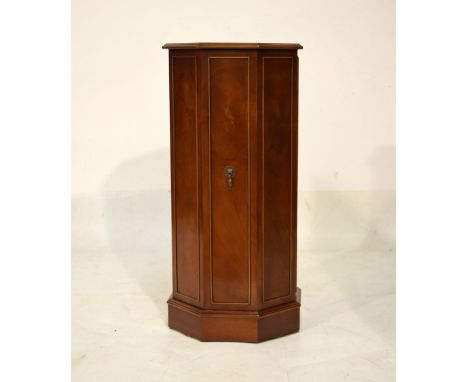 Reproduction yew finish octagonal drinks cabinet with hinged door enclosing a glass shelf, 41cm wide  