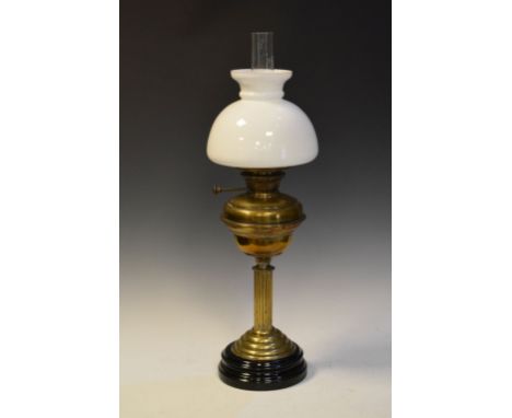 Late 19th/early 20th Century brass oil lamp on black ceramic base with funnel and shade, overall height 69cm  