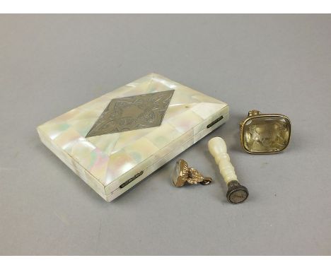 A citrine carved intaglio fob, depicting a coat of arms and mounted within yellow metal, together with a mother of pearl moun