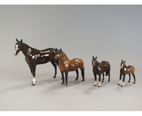 A group of four Beswick brown glass horses, differing sizes, together with a globe decanter painted with hearts and three mat