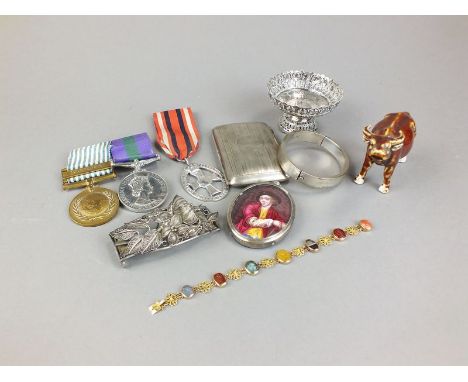 A carved hardstone set panel brooch, mounted in yellow metal, together with a silver cigarette case, a silver mounted portrai