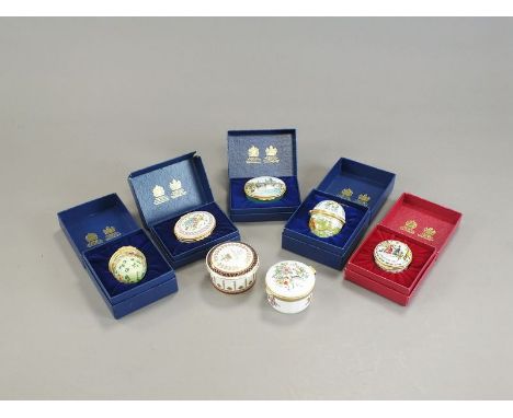 Sixteen Halcyon Days enamel pill boxes, comprising a miniature pair of black and gilt examples, initialled 'C' and 'P', 2.5cm