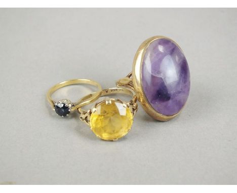 A 9ct gold amethyst dress ring, together with a paste set dress ring, stamped '9ct' and a single stone sapphire ring, stamped