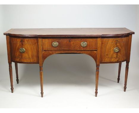 An early 19th century mahogany and satinwood crossbanded bow front sideboard, the reeded breakfront top above a boxwood and e