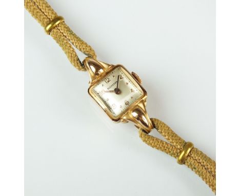 A lady's 18ct gold Bucherer cocktail watch, the oblong silvered dial with Arabic numerals, manual wind, with attached cord st